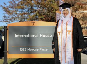 Ahoud Algargoush poses in graduation gown in front of the International House