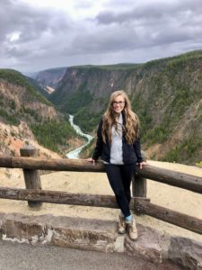 Leah in Yellowstone National Park posed in front of the Grand Canyon of Yellowstone