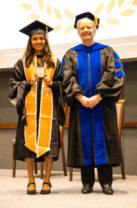 Bindica Poudel, graduating with a degree in chemical engineering, accepts a medallion from Dean of the Graduate School Dixie L. Thompson