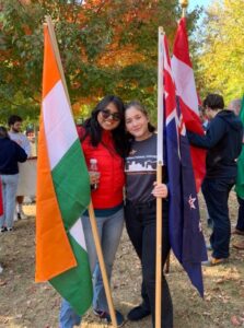 Students pose with flags at homecoming parade in 2022