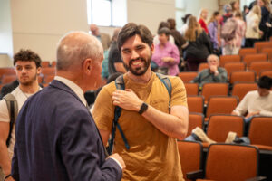 Roelf Meyer interacts with a student after the CGE Signature Global Dialogue